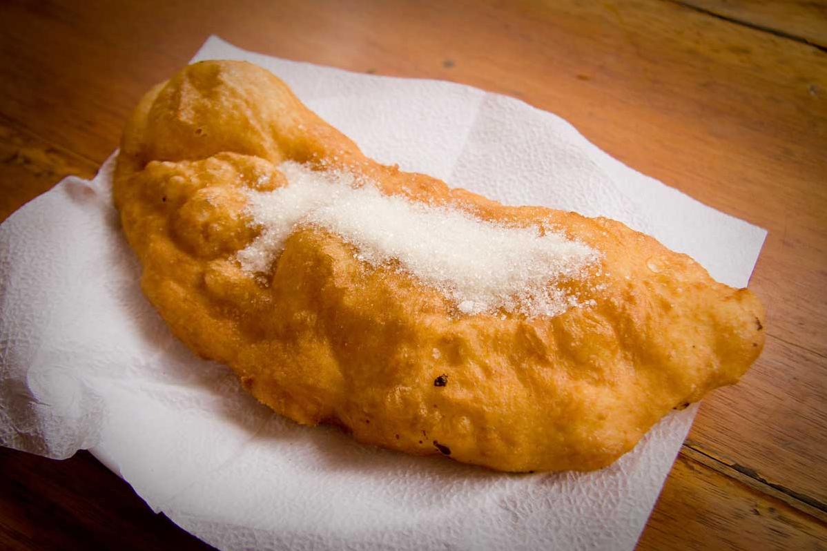  A close-up of golden cheese empanadas that are crispy on the outside and fluffy on the inside.