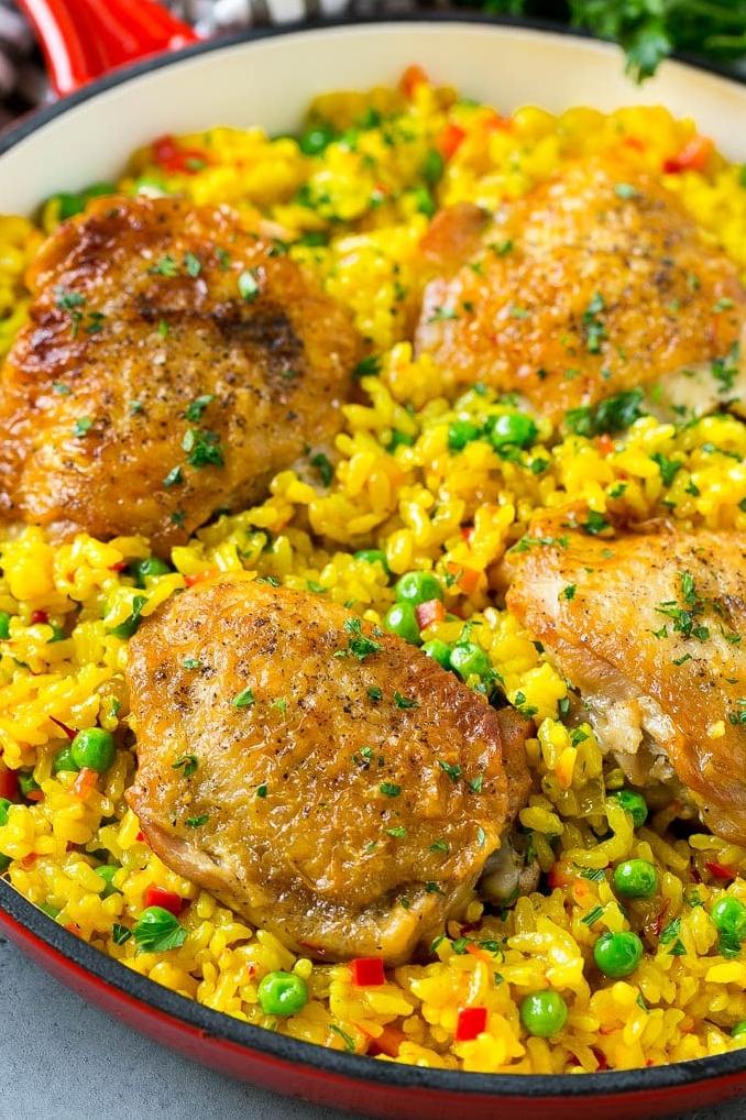  A colorful plate of Arroz con Pollo that's bound to make your taste buds dance with joy.