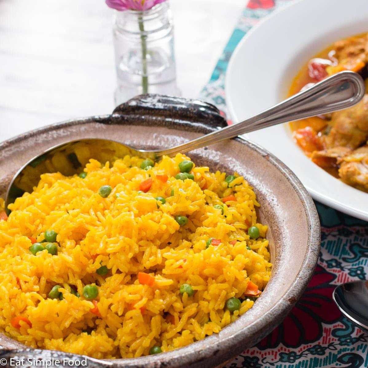  A vibrant and flavor-packed platter of Arroz Amarillo topped with fresh peas