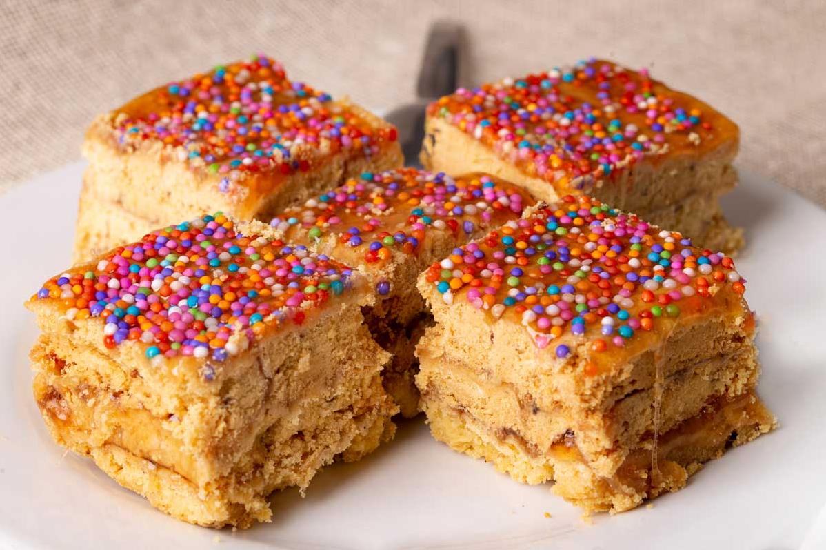  Crispy and colorful Turron De Dona Pepa served with a cup of steaming tea.