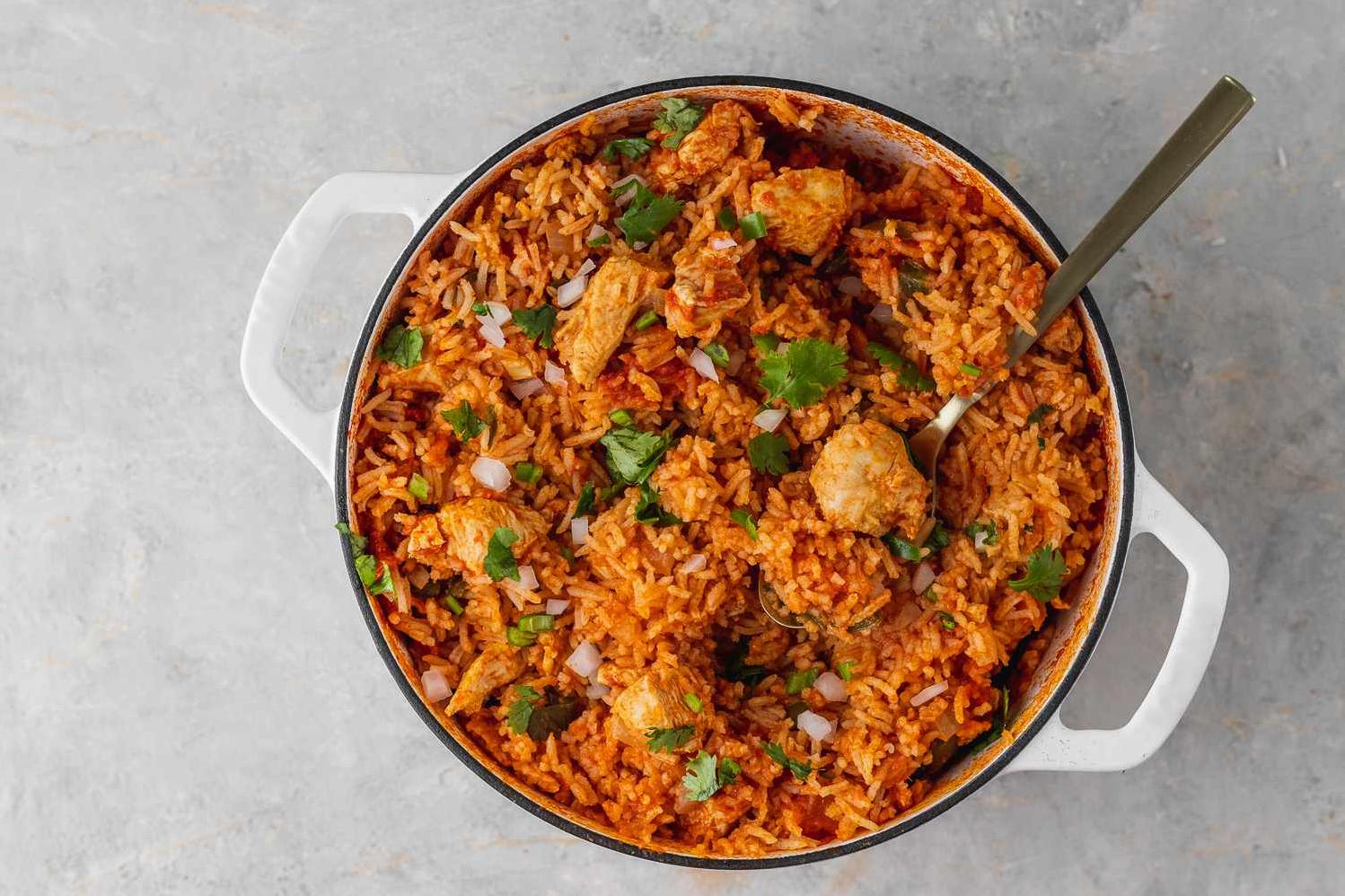  Tender chicken pieces sitting on a bed of aromatic rice, a feast for the eyes and the taste buds!