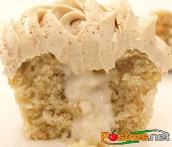  The golden brown cupcakes are topped with a dollop of whipped cream and cinnamon for extra flavor.