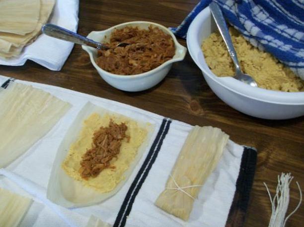  Tightly rolling the tamales to keep that stuffing inside