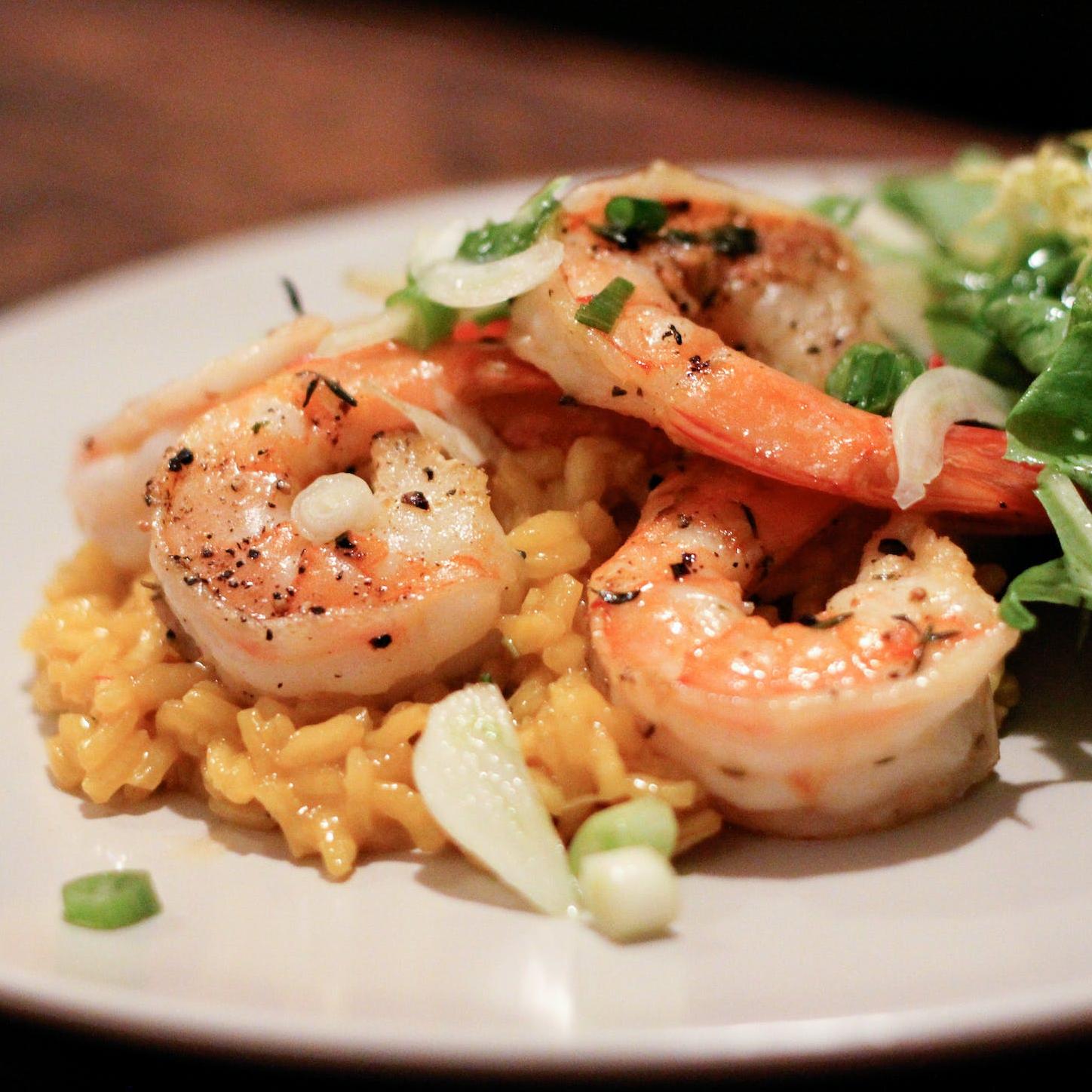  Transport yourself to the tropics with the flavors of our saffron-infused rice and savory shrimp.